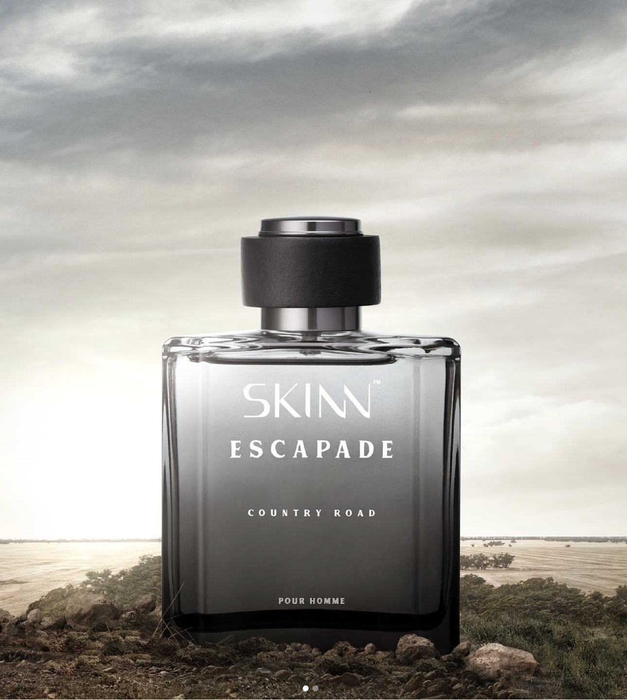 A Skinn Escapade Country Khad perfume bottle displayed on a beach background.