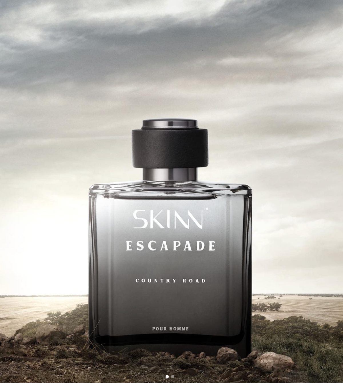A Skinn Escapade Country Khad perfume bottle displayed on a beach background.